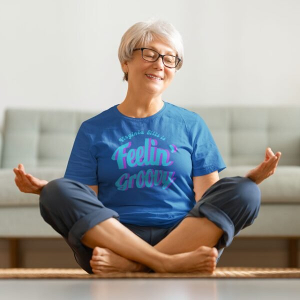 Senior woman does Yoga in Neon Blue Feelin Groovy T shirt