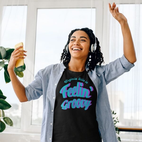 Young woman in Feelin’ Groovy personalized shirt dancing to her music