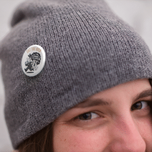 Mock up of Eat the Rich economic collapse button on gray hat